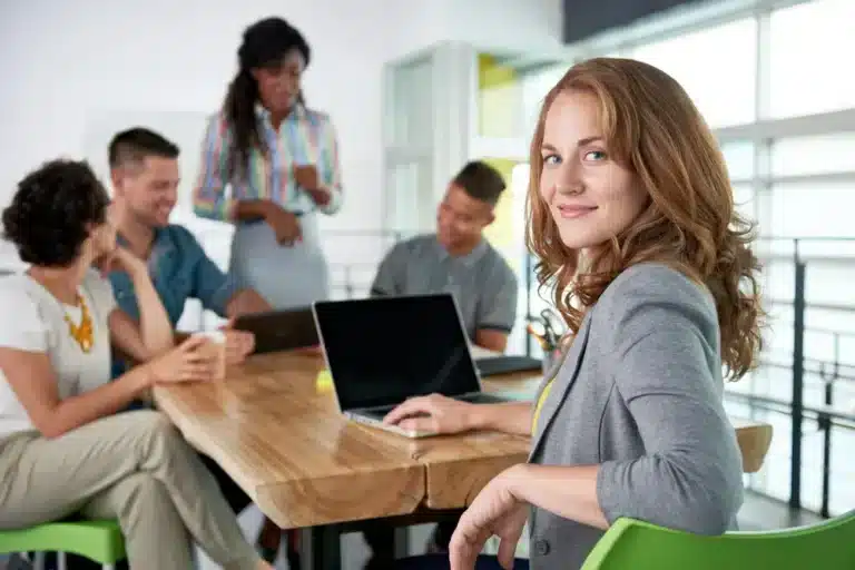 Image-of-a-succesful-casual-business-woman-using-laptop-during-meeting-768x512